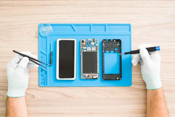 young-man-fixing-a-smartphone-with-tweezers-2026-03-16-06-44-14-utc-69e0d2328b10a